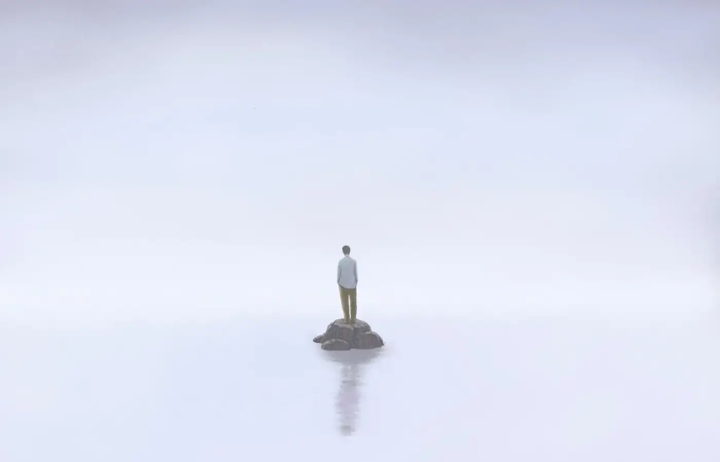Man standing on a rock in the middle of water