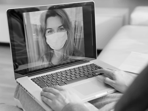 Woman wearing a mask in a video call.